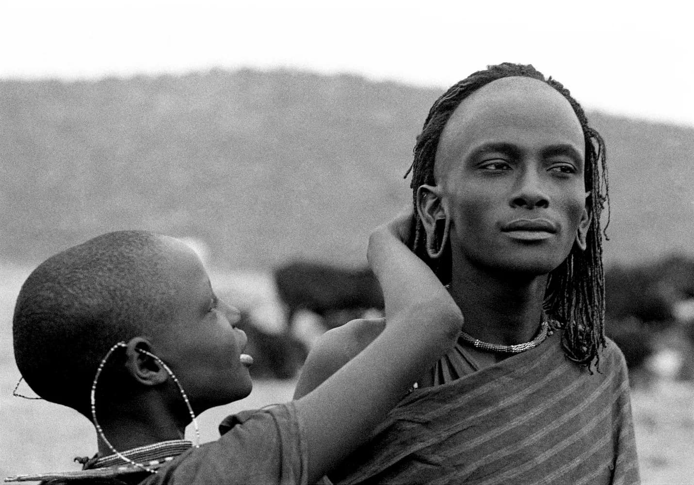 Maasai Girl Caressing Warrior's Hair